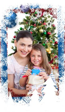 Composite image of mother and daughter at home at christmas time