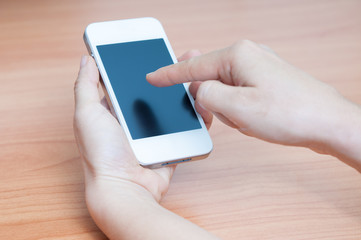 Close up of hands woman using her cell phone.