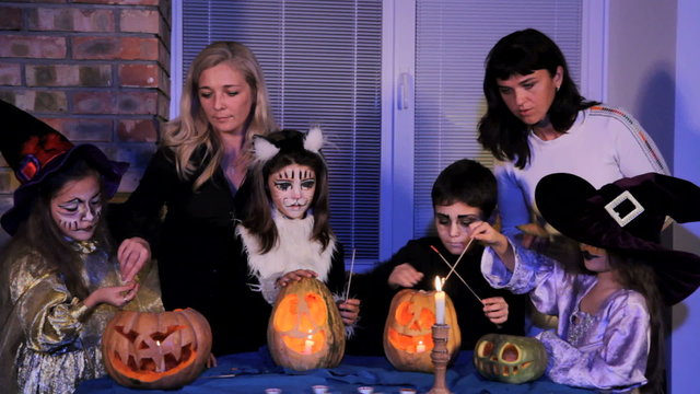 Group of Children And Adults Light  Halloween Candles