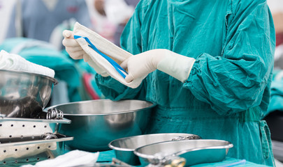 scrub nurse preparing tools for operation