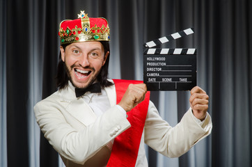 King with movie board in funny concept