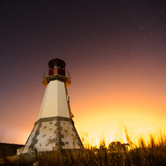 lighthouse with night sky at background stars trails - 70725616