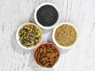 Four bowls of nuts and seeds