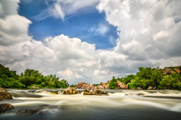 Beautiful river flow with sky stormy clouds,  moving water - lon - 70725841