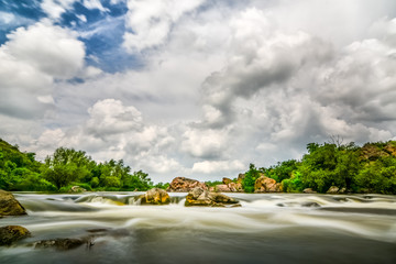 Beautiful river flow with sky stormy clouds,  moving water - lon - 70725853