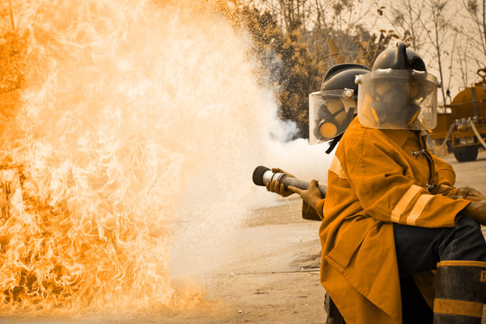 Firemen in action fighting fire during training