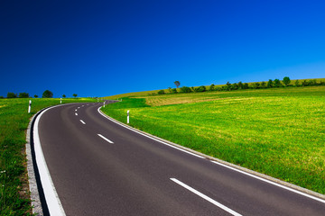 Empty highway in the beautiful sunny weather and clear blue sky