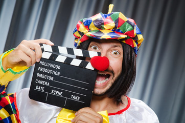Clown with movie clapper board
