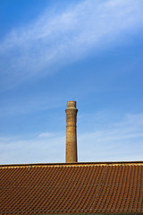 Old brick chimney isolated on sky