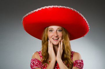 Mexican woman wearing red sombrero