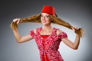 Woman wearing red fez hat