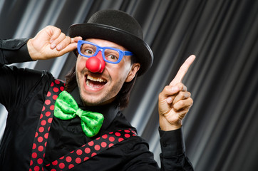  Funny clown in humorous concept against curtain