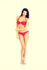 Fototapeta premium Beautiful young woman in a red bikini
