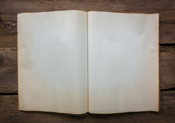 Open blank pages of old book on wood background