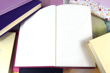 Blank pages in open book on book background