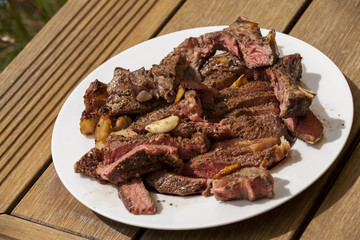 Plate of Grilled Steak and Garlic with Red Napkin