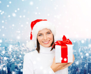 smiling woman in santa helper hat with gift box