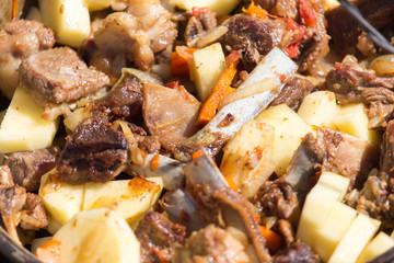 meat with potatoes in a cauldron