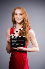 Woman in red dress with movie board