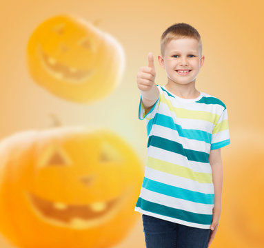 smiling boy over pumpkins background