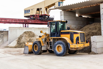 Parked pay loader near pile of dirt