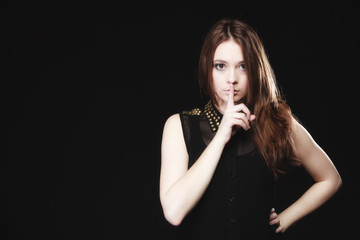 Obraz premium Secret woman. Girl showing hand silence sign