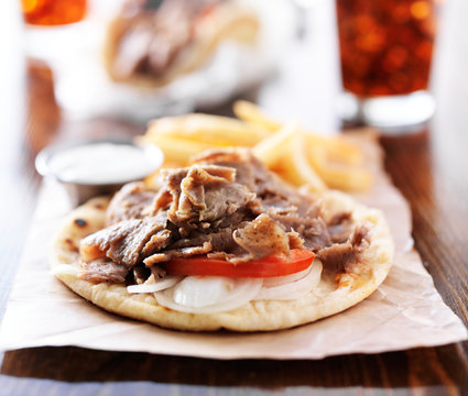 open greek gyros with tzatkiki sauce and fries