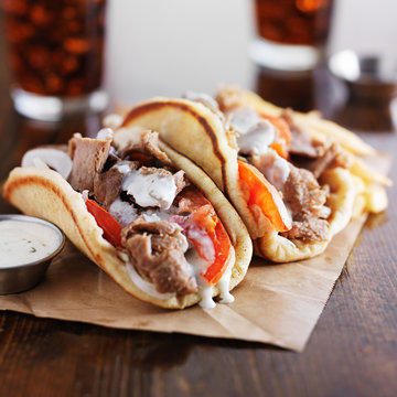 authentic greek gyros with tzatkiki sauce, cola and fries