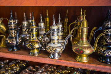 Fototapeta na wymiar row of shiny traditional coffee pots and lamp