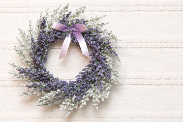 Wreath with lavender flowers on lace fabric background