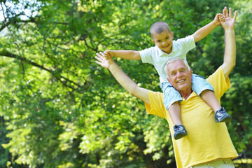 happy grandfather and child in park