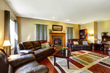 Fototapeta premium Living room interior with leather couches and fireplace
