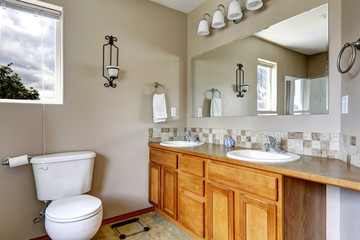 Fototapeta na wymiar Bathroom cabinet with two sinks and tile trim