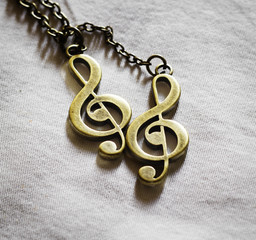 Metal music clef on fabric background