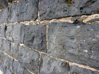 Close-up of a old Cemented lava stone wall