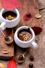 flavored hot chocolate in small ceramic chashkahna wooden table