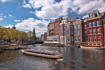 Amsterdam city with boats on canal in Holland