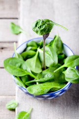 Baby spinach in a blue ceramic bowl