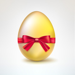 Golden egg with red bow.