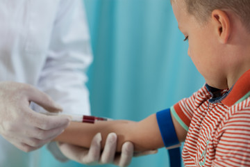 Nurse making boy blood sampling