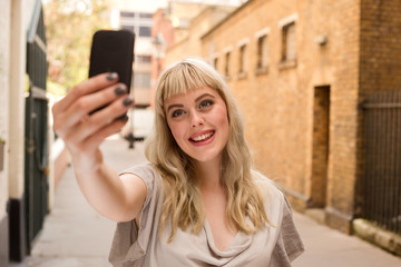 young woman taking a selfie.