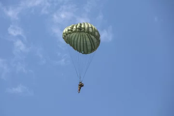 Tuinposter Parachutist in the war © Tuomas Kujansuu