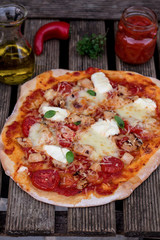 Homemade pizza with tomato sauce, tomatoes and mozzarella