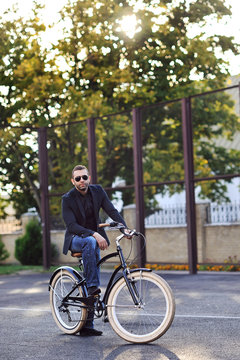 Young stylish man with retro bicycle outdoor