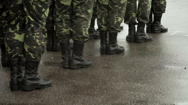 Soldiers in camouflage military uniform rest position
