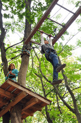children having fun  in a climbing adventure activity park