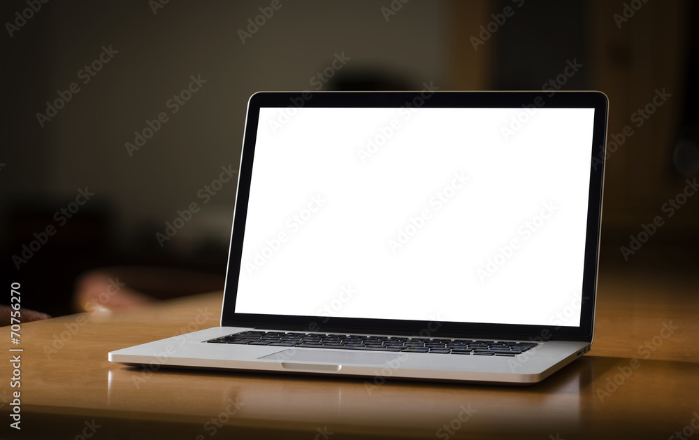 Poster notebook with blank screen on table in home interior