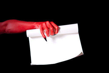 Red devil hand holding paper scroll