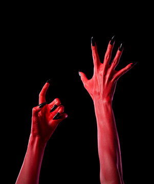 Red spooky devil hands with black nails, real body-art