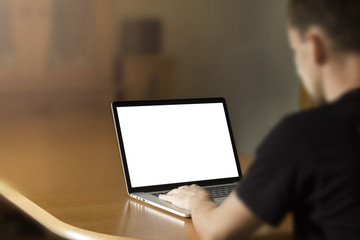 Man working on notebook with blank screen.